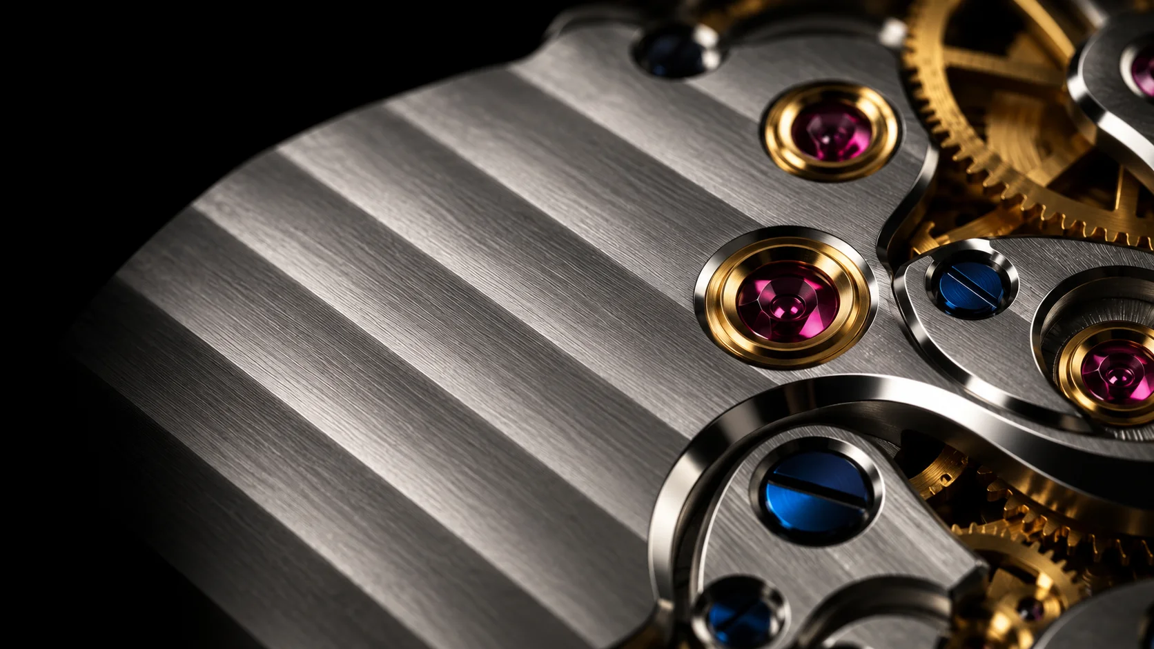 Close-up of a brushed steel watch bridge with Geneva stripes, gold-rimmed ruby jewels, blue screws and a brass gear
